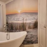 Wall Murals - View of the sea and sand at sunset on an adhesive mural, perfect for transforming the bathroom into an oasis