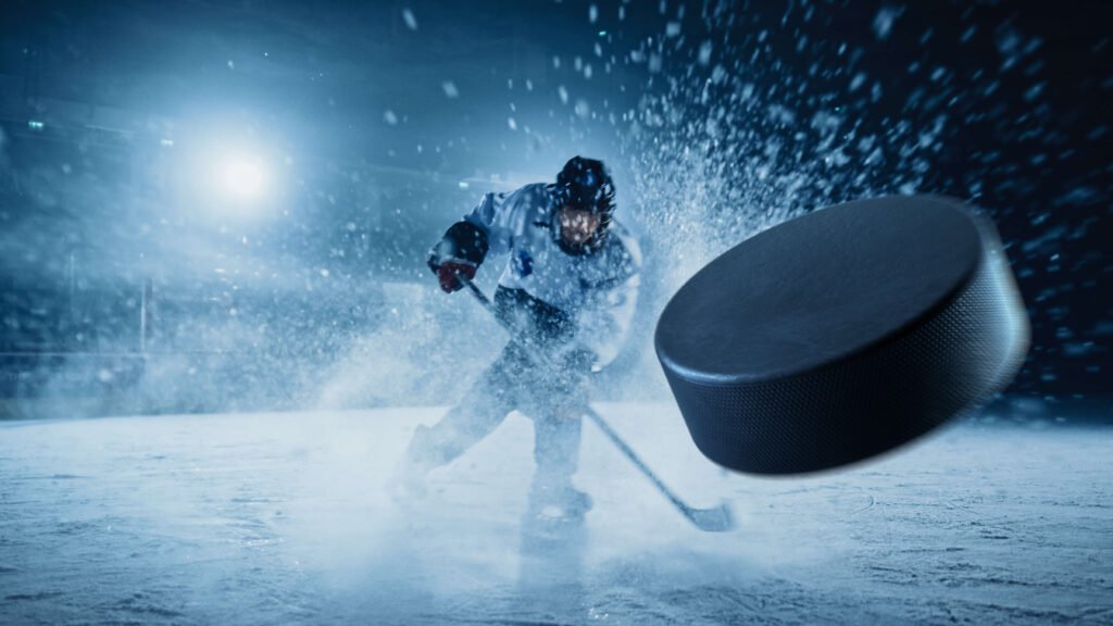 hockey player hitting the hockey puck